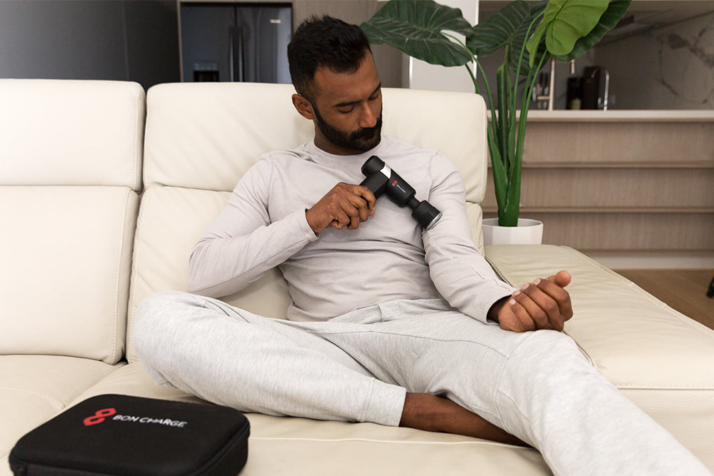 Man Applying the Cold & Heat Therapy Massage Gun to Upper Arm