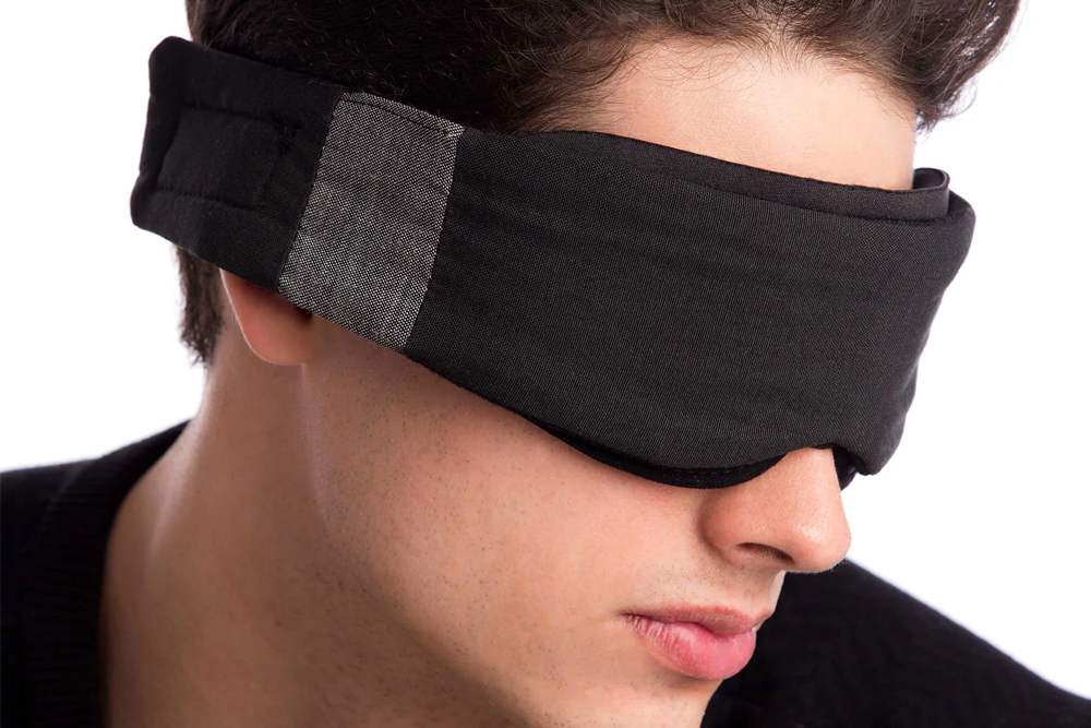 Man Wearing Low-Profile Contoured Blackout Sleep Mask
