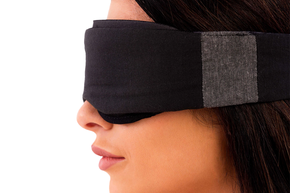 Woman Stood Sideways Wearing Low-Profile Contoured Blackout Sleep Mask